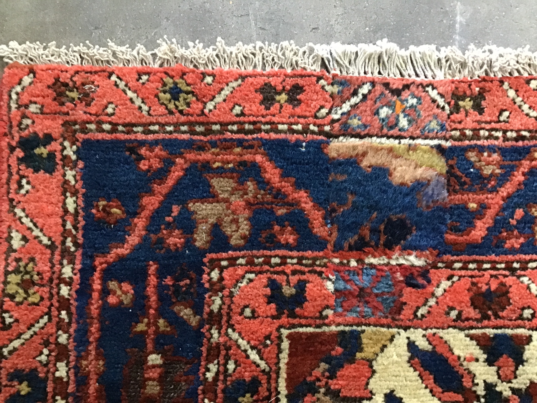 A North West Persian blue ground rug woven with rows of boteh, 196cm x 126cm
